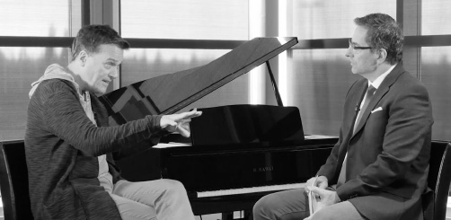 An interview for This is Your Story in front of a concert piano.